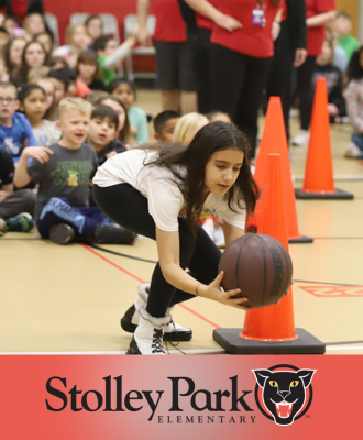  Student reaching for a basketball during a game.